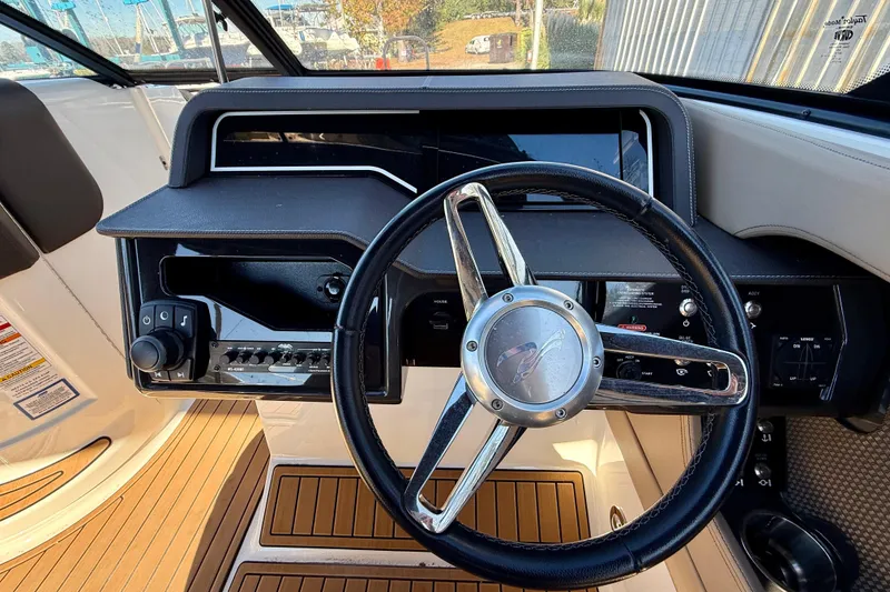 Slide: The Image of Steering wheel and dashboard of a 2016 Sea Ray 280 SLX boat. - 10