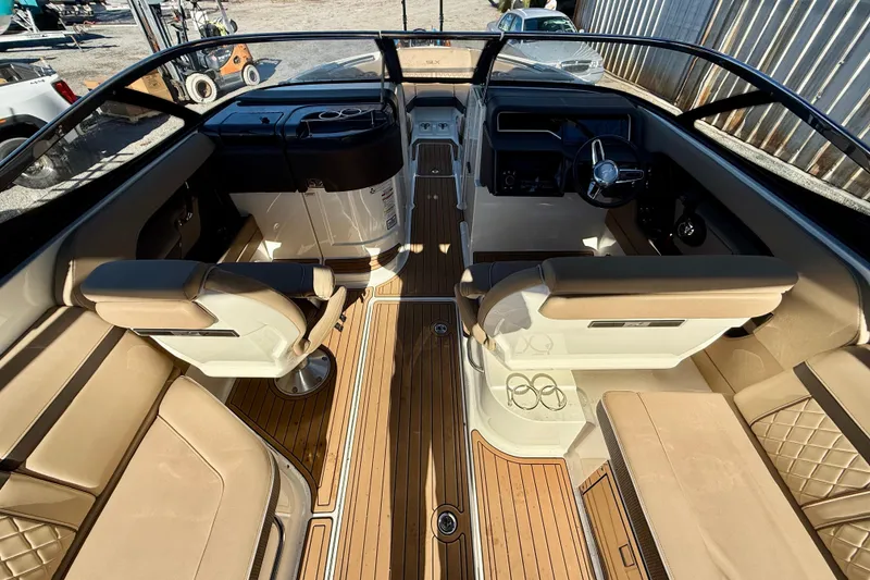 Slide: The Image of 2016 Sea Ray 280 SLX boat interior with tan seating and wood flooring. - 12