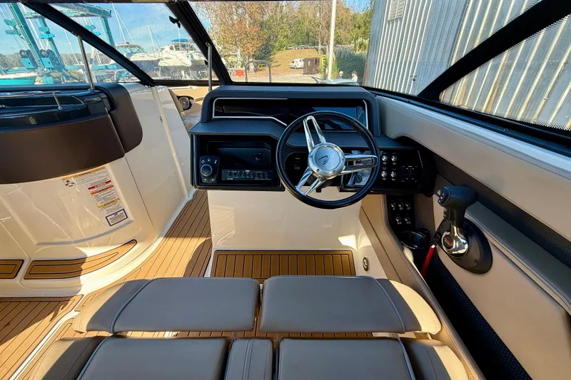 Slide: The Image of 2016 Sea Ray 280 SLX boat interior with steering wheel and control panel. - 13