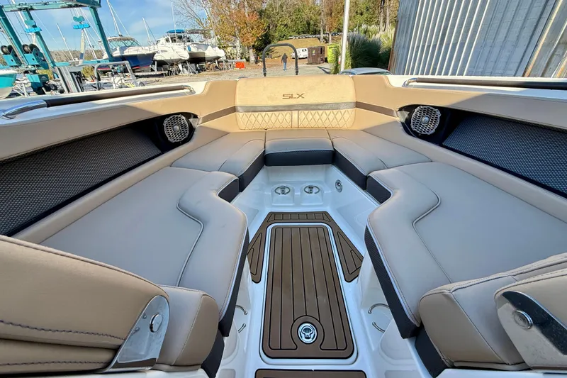 Slide: The Image of Luxurious interior of 2016 Sea Ray 280 SLX boat with plush seating and wood accents. - 14