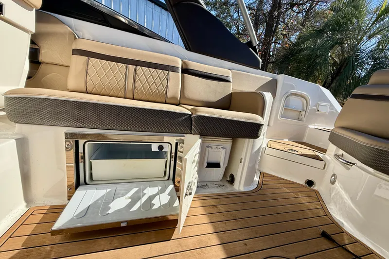 Slide: The Image of 2016 Sea Ray 280 SLX boat interior with seating and open storage compartment. - 17