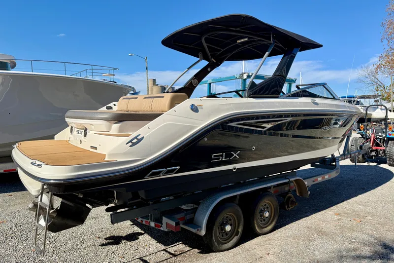 Slide: The Image of 2016 Sea Ray 280 SLX boat on trailer, sleek design, outdoor setting. - 2
