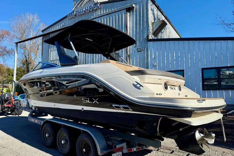 Slide: The Image of 2016 Sea Ray 280 SLX boat on trailer, parked outside a metal building. - 3