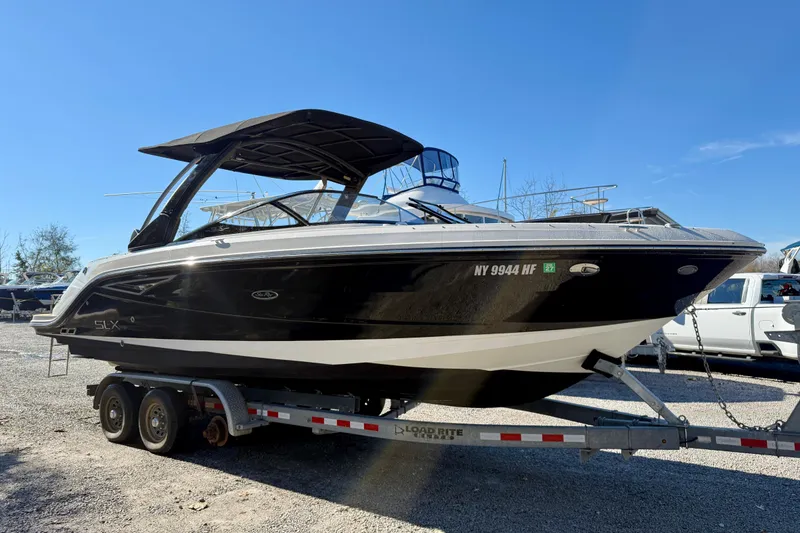 Slide: The Image of 2016 Sea Ray 280 SLX boat on trailer under clear blue sky. - 4