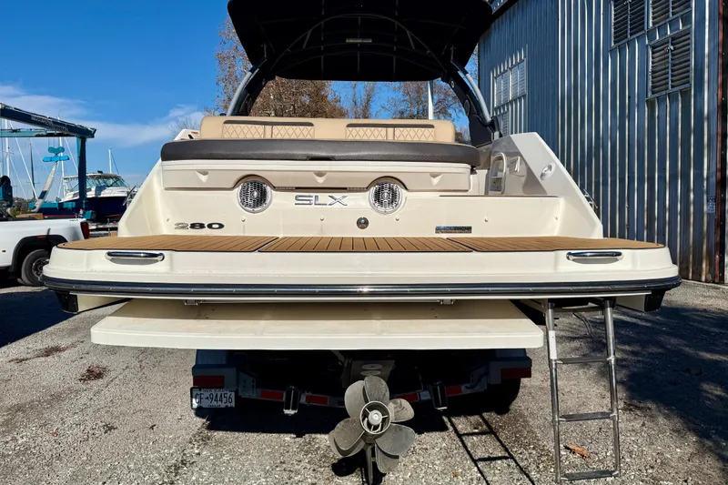 Slide: The Image of 2016 Sea Ray 280 SLX boat with swim platform and ladder, docked outdoors. - 5