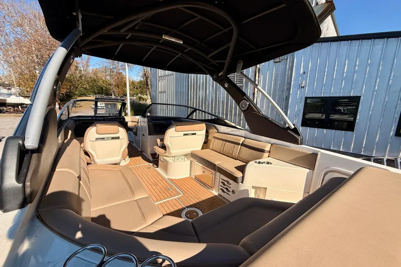 Slide: The Image of 2016 Sea Ray 280 SLX boat interior with tan seating and wood flooring. - 6