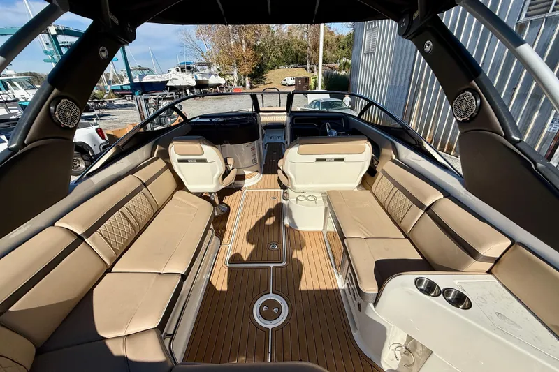 Slide: The Image of Interior of a 2016 Sea Ray 280 SLX boat with tan seating and wood flooring. - 7