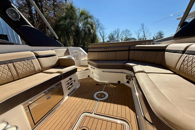 Slide: The Image of Luxurious interior of 2016 Sea Ray 280 SLX boat with tan seating and wood flooring. - 8