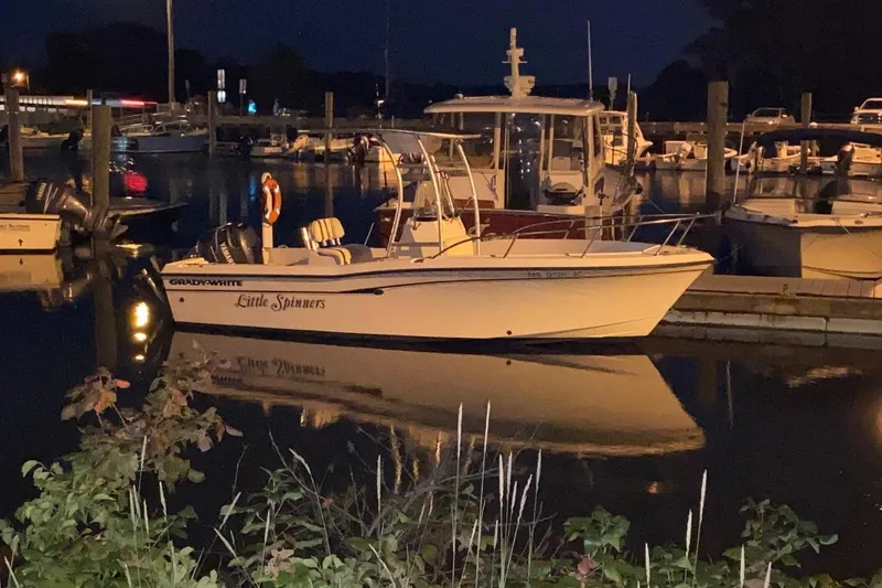 Slide: The Image of 2001 Grady-White Escape 209 boat on calm water under cloudy sky. - 2