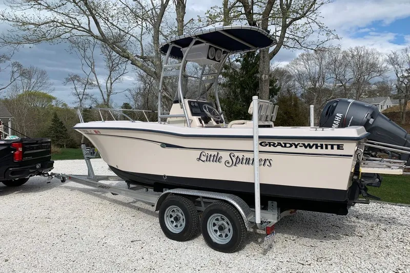 Slide: The Image of 2001 Grady-White Escape 209 boat docked at night, reflecting on calm water. - 3