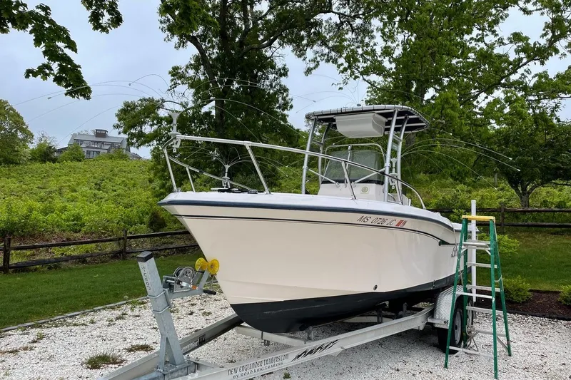 Slide: The Image of 2001 Grady-White Escape 209 boat on trailer, surrounded by lush greenery. - 4