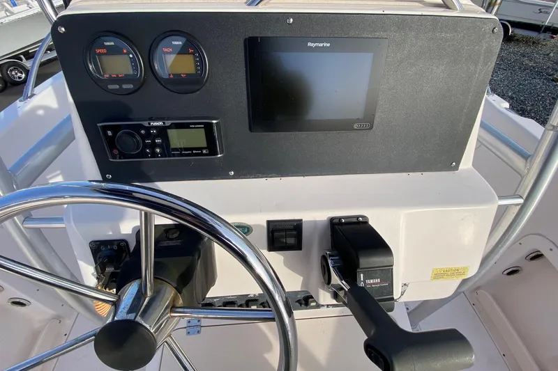 Slide: The Image of 2001 Grady-White Escape 209 boat dashboard with steering wheel and navigation controls. - 5