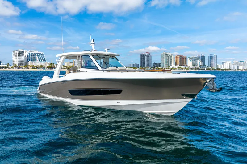 The Image of 2024 Boston Whaler 420 Outrage cruising near city skyline on a sunny day. - 0