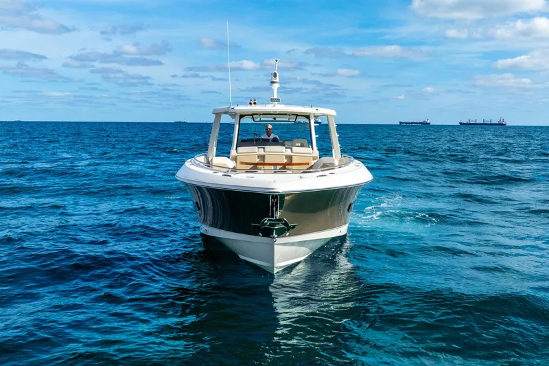 Slide: The Image of 2024 Boston Whaler 420 Outrage cruising on open ocean under blue sky. - 11