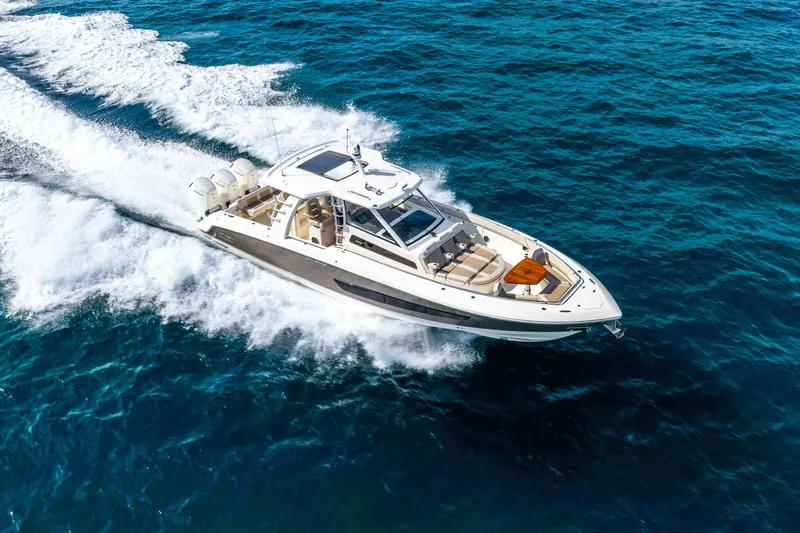 Slide: The Image of 2024 Boston Whaler 420 Outrage cruising on open blue ocean waters. - 12