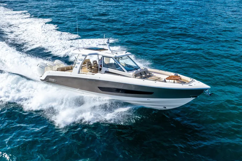 Slide: The Image of 2024 Boston Whaler 420 Outrage cruising on open ocean waters. - 13