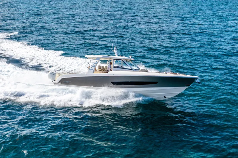 Slide: The Image of 2024 Boston Whaler 420 Outrage cruising on open ocean waters. - 14