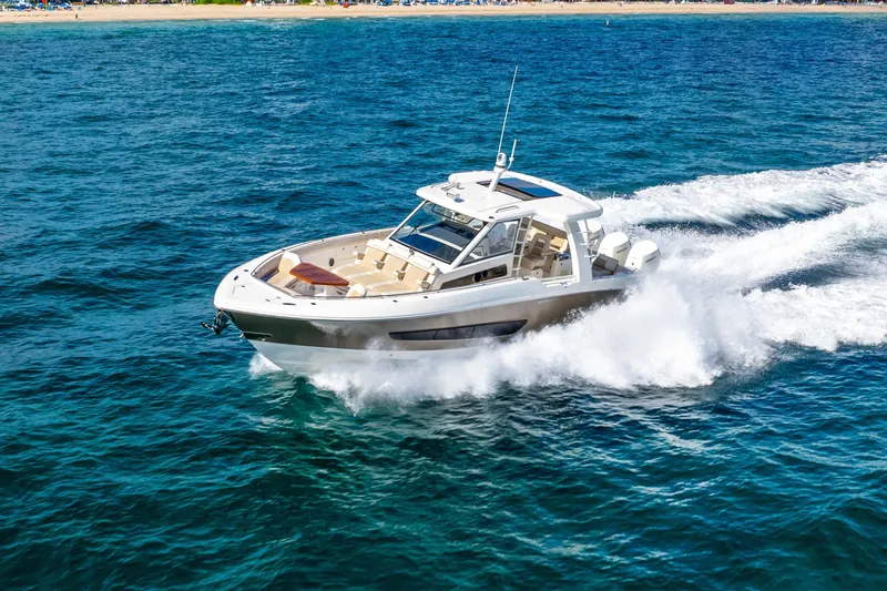 Slide: The Image of 2024 Boston Whaler 420 Outrage cruising on open water, showcasing sleek design and performance. - 18