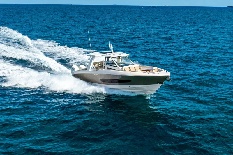 Slide: The Image of 2024 Boston Whaler 420 Outrage cruising on open blue ocean waters. - 23