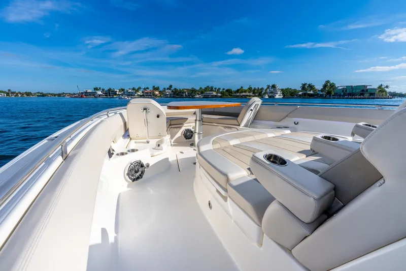 Slide: The Image of 2024 Boston Whaler 420 Outrage boat interior with luxurious seating and ocean view. - 25