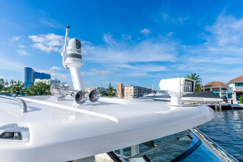 Slide: The Image of 2024 Boston Whaler 420 Outrage boat with advanced navigation equipment, docked in a marina. - 32