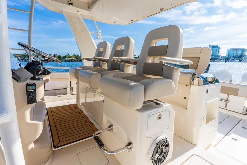 Slide: The Image of 2024 Boston Whaler 420 Outrage helm with luxurious seating and modern controls. - 34