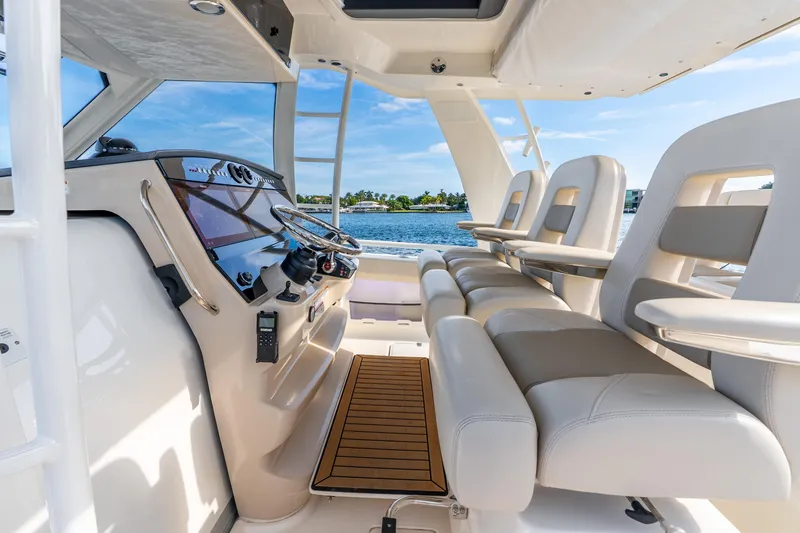 Slide: The Image of 2024 Boston Whaler 420 Outrage interior with luxurious seating and modern helm controls. - 36