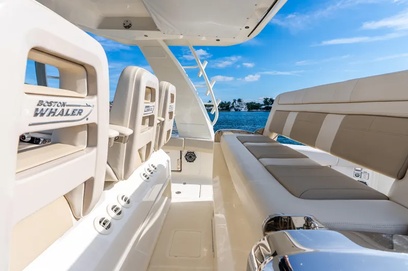 Slide: The Image of 2024 Boston Whaler 420 Outrage interior with luxurious seating and ocean view. - 37
