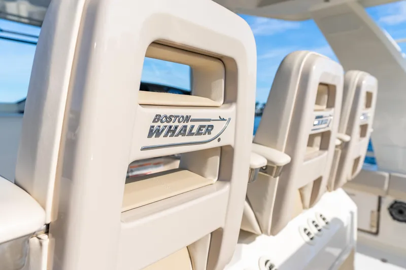 Slide: The Image of 2024 Boston Whaler 420 Outrage boat seats with logo, showcasing luxury design. - 38