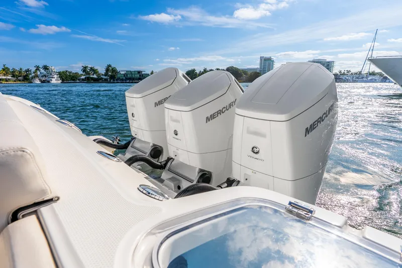 Slide: The Image of 2024 Boston Whaler 420 Outrage with triple Mercury outboard engines on water. - 40