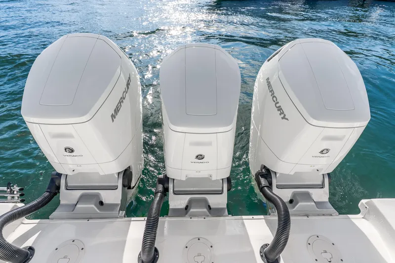 Slide: The Image of 2024 Boston Whaler 420 Outrage with triple Mercury Verado engines on water. - 41