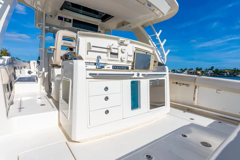 Slide: The Image of 2024 Boston Whaler 420 Outrage boat interior with modern helm and seating. - 48