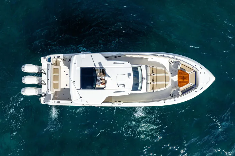 Slide: The Image of 2024 Boston Whaler 420 Outrage boat on clear blue water, aerial view. - 5