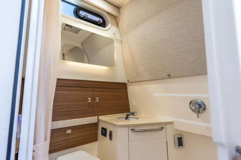 Slide: The Image of 2024 Boston Whaler 420 Outrage bathroom with modern sink and wood accents. - 53