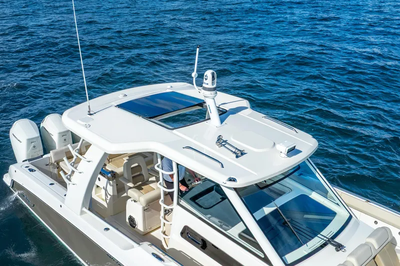 Slide: The Image of 2024 Boston Whaler 420 Outrage cruising on open water, showcasing sleek design and advanced features. - 6