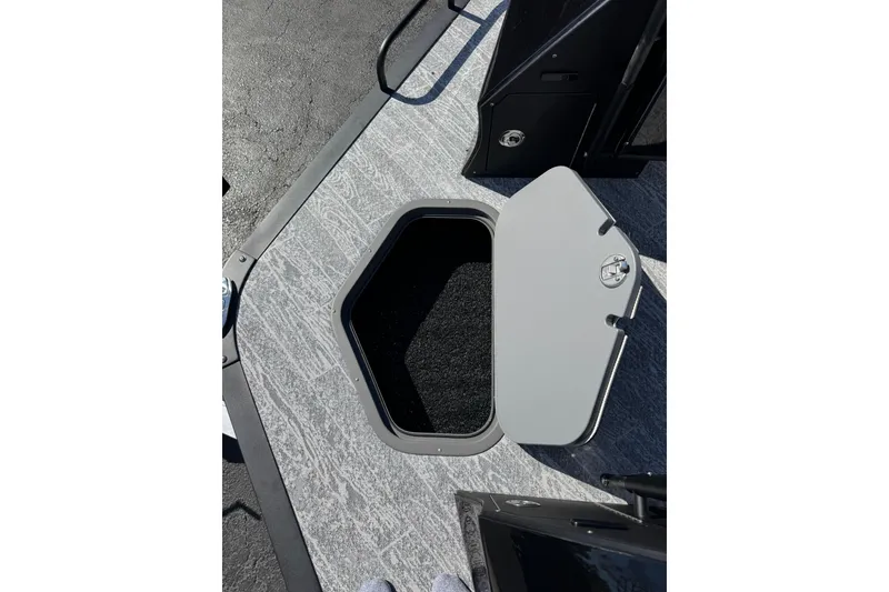 Slide: The Image of Open storage compartment on 2026 JC 24 SportToon TT boat deck. - 13