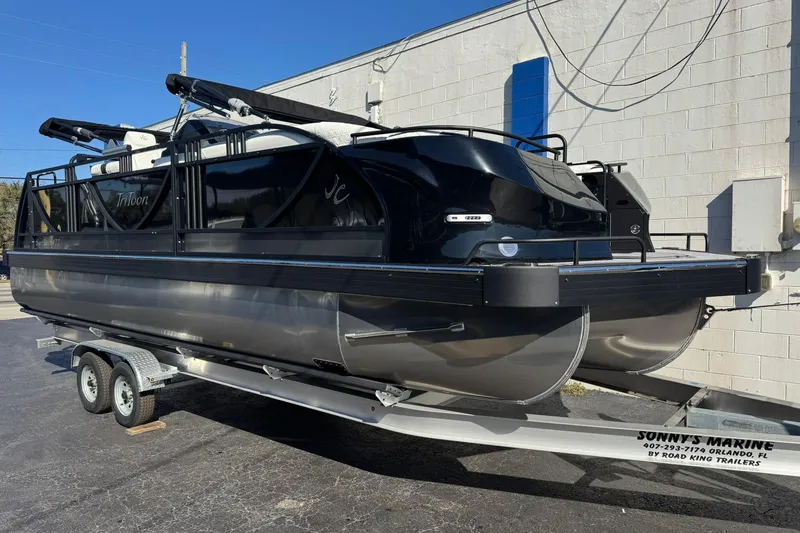 Slide: The Image of 2026 JC 24 SportToon TT pontoon boat on trailer, black and silver design. - 9