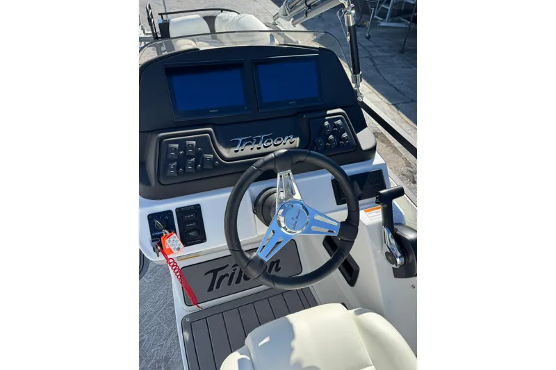 Slide: The Image of Steering console of 2026 JC 24 SportToon TT boat with dual screens and controls. - 17
