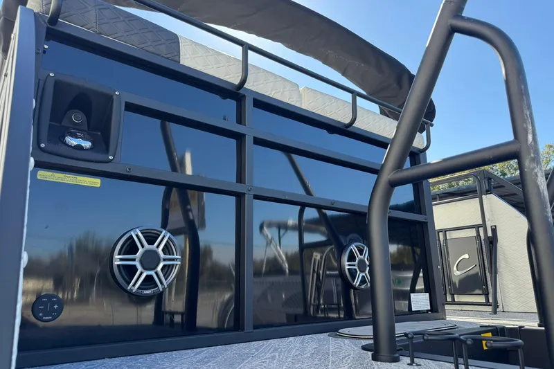 Slide: The Image of 2026 JC 24 SportToon TT boat with speakers and ladder, showcasing modern design features. - 24