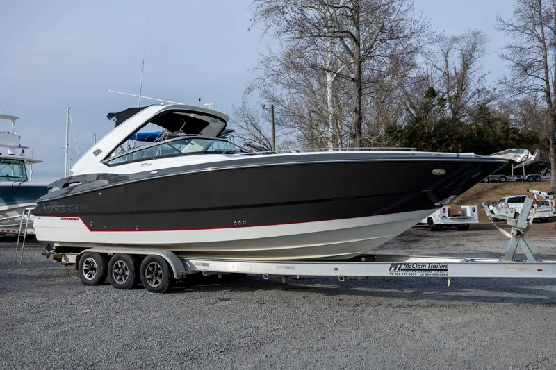 Slide: The Image of 2015 Monterey 328SS Super Sport boat on trailer at marina with other boats. - 10