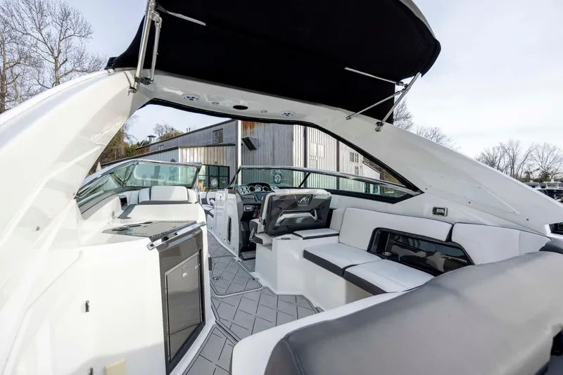 Slide: The Image of 2015 Monterey 328SS Super Sport boat interior with sleek design and modern steering wheel. - 20