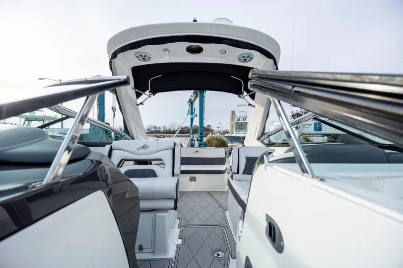 Slide: The Image of Interior cabin of 2015 Monterey 328SS Super Sport boat with striped bedding and control panels. - 27