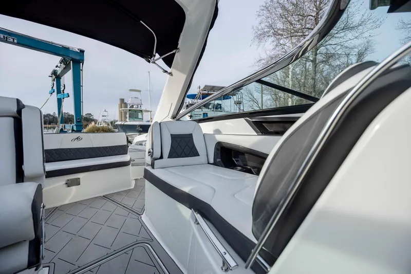 Slide: The Image of 2015 Monterey 328SS Super Sport cabin interior with striped bedding and porthole window. - 28