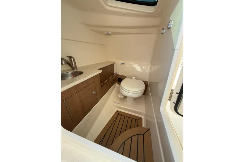 Slide: The Image of 2018 Boston Whaler 270 Vantage boat interior with sink and toilet. - 14