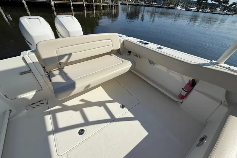 Slide: The Image of 2018 Boston Whaler 270 Vantage boat interior with seating and twin engines. - 15