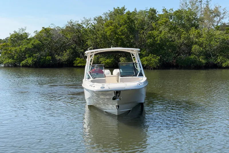 Slide: The Image of 2018 Boston Whaler 270 Vantage boat on calm water with lush greenery background. - 3