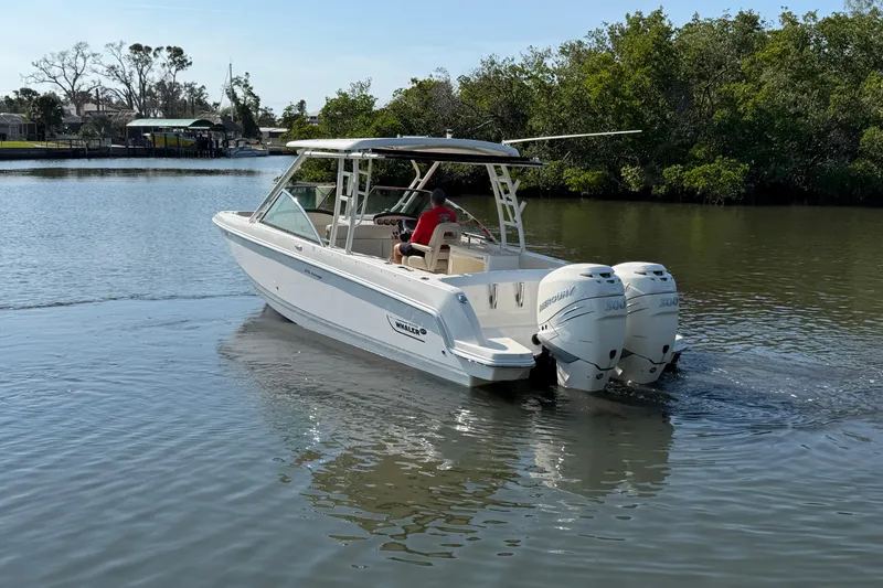 Slide: The Image of 2018 Boston Whaler 270 Vantage boat cruising on a calm river. - 6