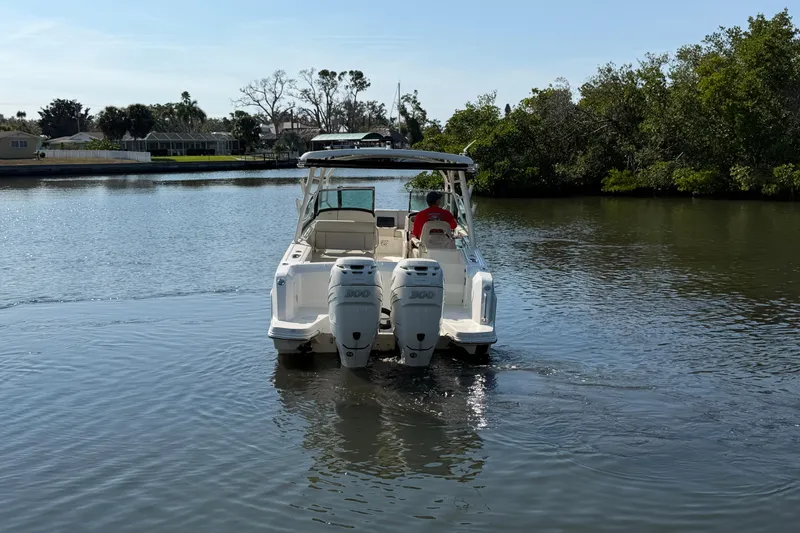 Slide: The Image of 2018 Boston Whaler 270 Vantage boat cruising on a calm river. - 7