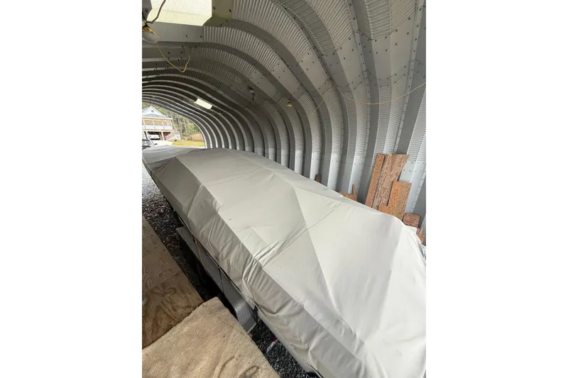 Slide: The Image of Covered 1988 Thunderbird Formula 311 SR1 boat in a metal storage shelter. - 13