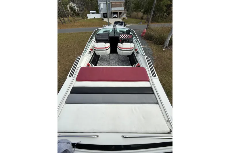 Slide: The Image of 1988 Thunderbird Formula 311 SR1 boat with red and white seating, parked outdoors. - 17